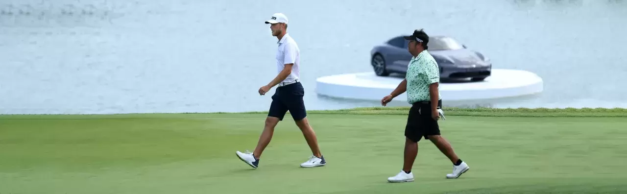 Jesper Svensson of Sweden and Kiradech Aphibarnrat of Thailand walk on the 18th green at the playoff during Day Four of the Porsche Singapore Classic at Laguna National Golf Resort Club
