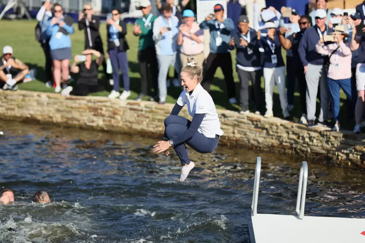  Nelly Korda of the United States jumps into the water after winning The Chevron Championship at The Club at Carlton Woods on April 21, 2024 in The Woodlands, Texas