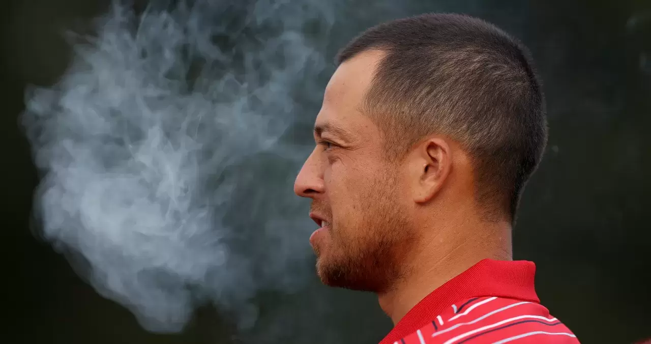 Xander Schauffele of the United States Team smokes a cigar in celebration of the United States Team defeating the International Team 