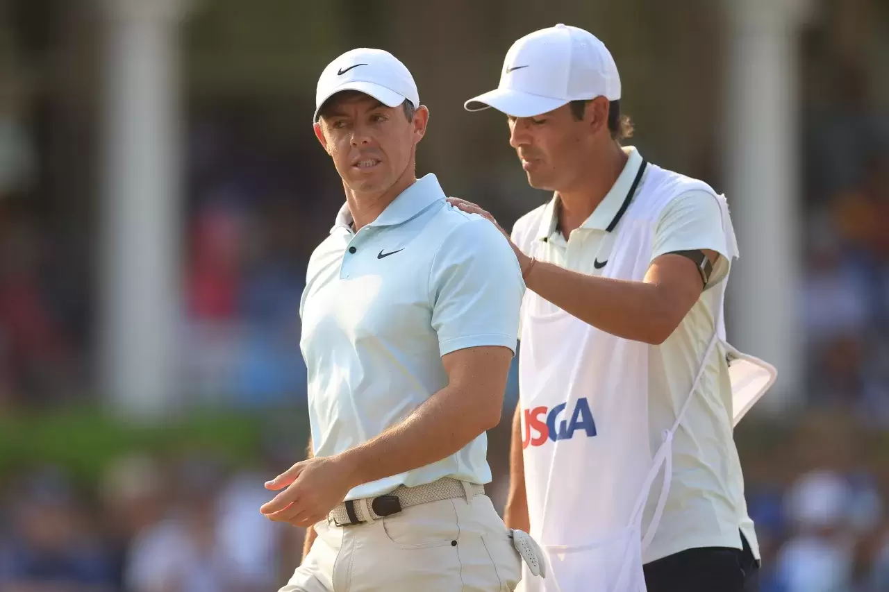 Rory McIlroy of Northern Ireland is consoled by his caddie Harry Diamond after making a bogey on the 18th hole during the final round of the 124th U.S. Open at Pinehurst Resort on June 16, 2024 in Pinehurst