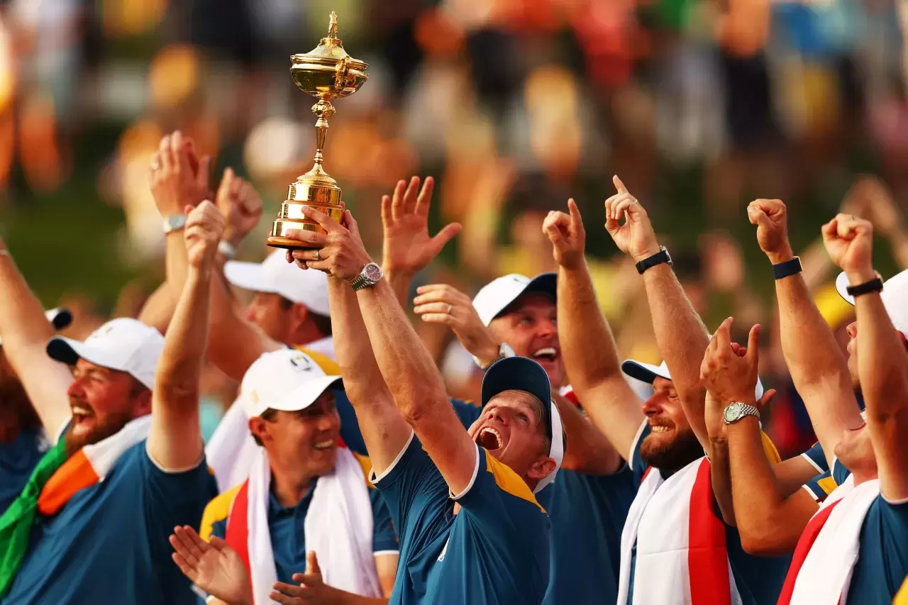 Team Europe Captain Luke Donald lifts the trophy with his team after his team win during the Sunday singles matches of the 2023 Ryder Cup at Marco Simone Golf Club on October 01, 2023 in Rome, Italy.