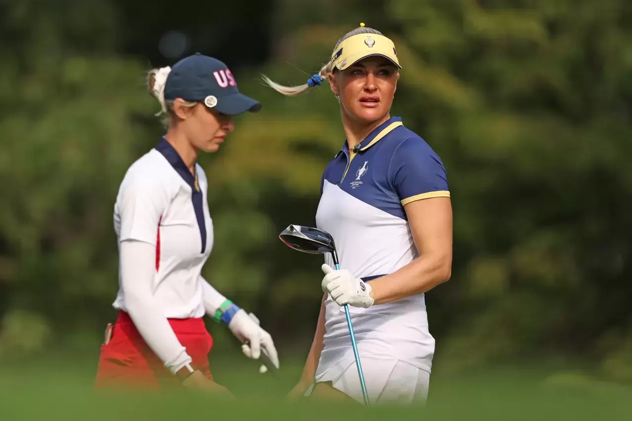 Nelly Korda of Team United States and Charley Hull of Team Europe walk on the third tee during the Sunday Singles matches during the final round of the Solheim Cup 2024