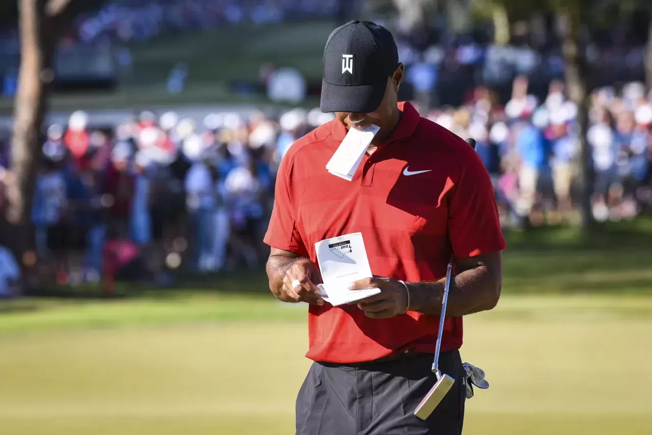 Tiger Woods marks his scorecard after missing a par putt on the 16th hole green during the final round of the Arnold Palmer Invitational presented by MasterCard at Bay Hill Club