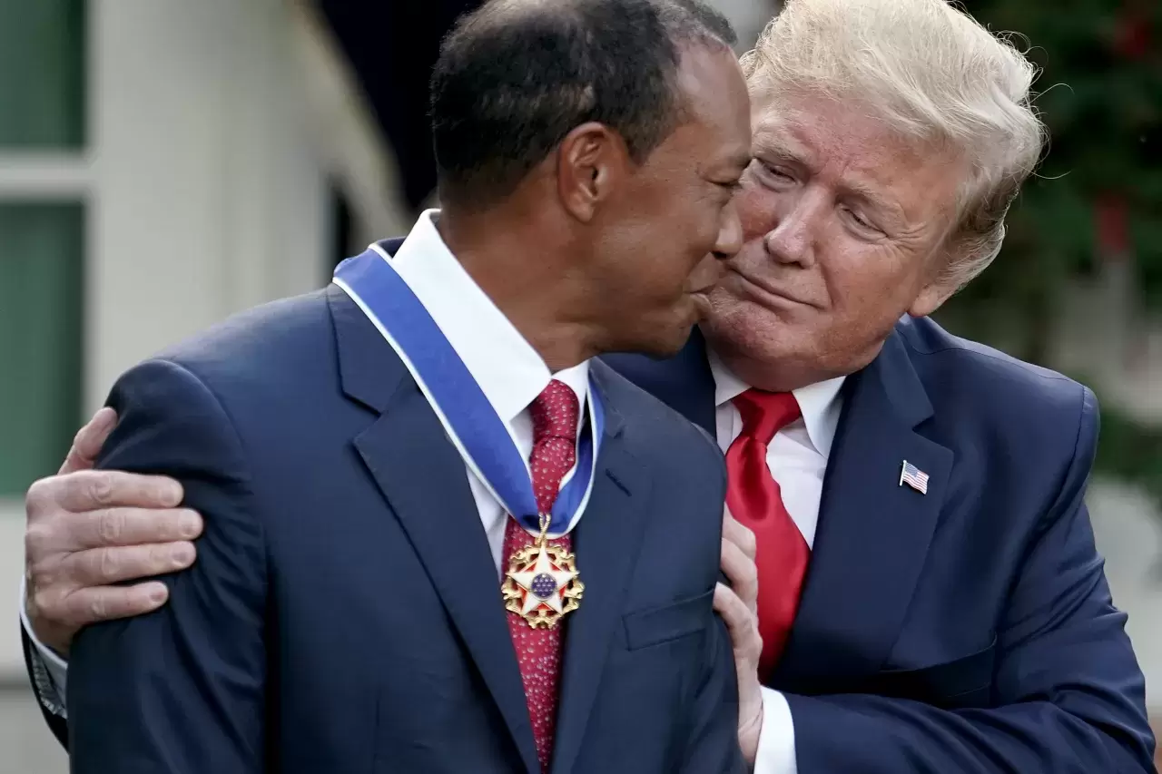 Donald Trump gives professional golfer and business partner Tiger Woods the Medal of Freedom during a ceremony in the Rose Garden at the White House