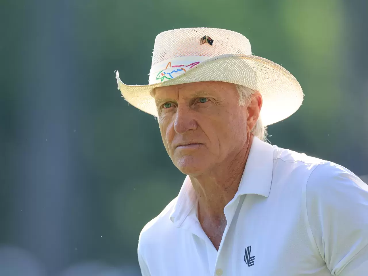 Greg Norman of Australia The Commissioner of The LIV Golf Tour watching some of his players in amongst the patrons during the completion of the weather delayed first round of the 2024 Masters Tournament at Augusta National Golf Club 