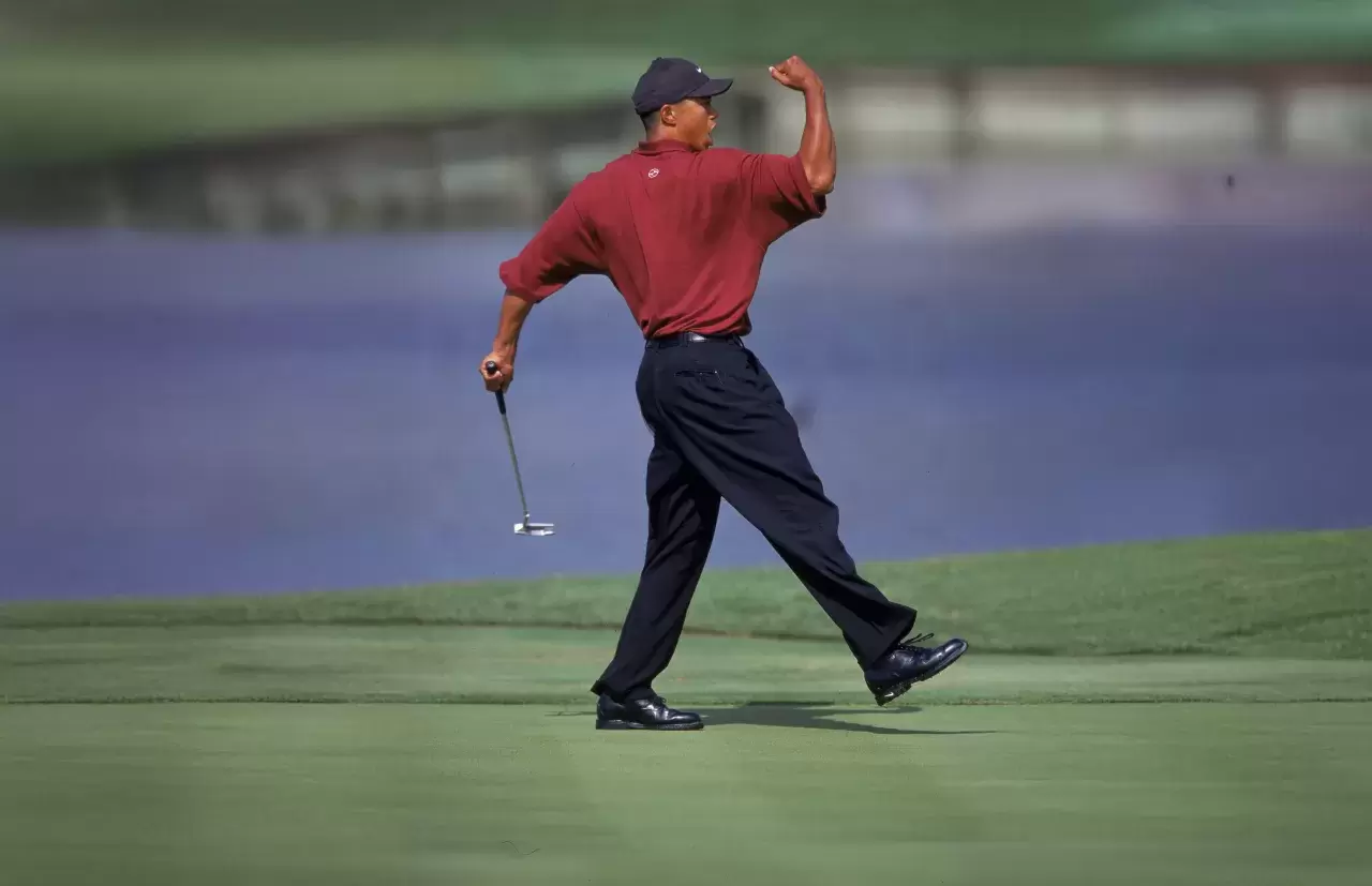 Tiger Woods celebrates after putting the ball during the Players Championship TPC at Sawgrass in Point Vedra Beach, Florida.-2000