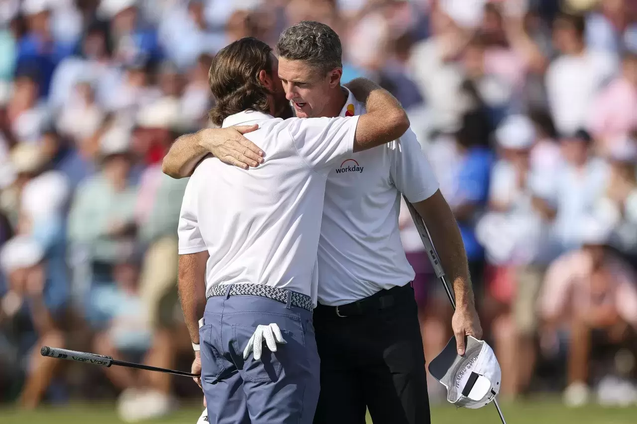 Justin Rose of England hugs Tommy Fleetwood of England on the 18th hole green after finishing the final round of the FedEx St. Jude Championship 2025 at TPC Southwind on August 10, 2025 in Memphis, Tennessee swiss golf