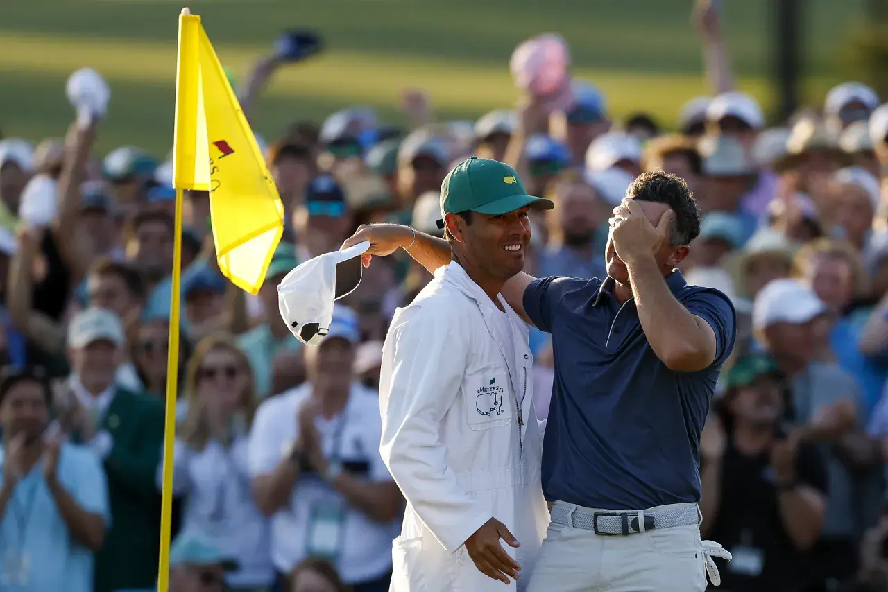 Rory McIlroy of Northern Ireland celebrates winning with caddie Harry Diamond after the playoff hole during the final round of the 2025 Masters Tournament at Augusta National Golf Club on April 13-2210128031