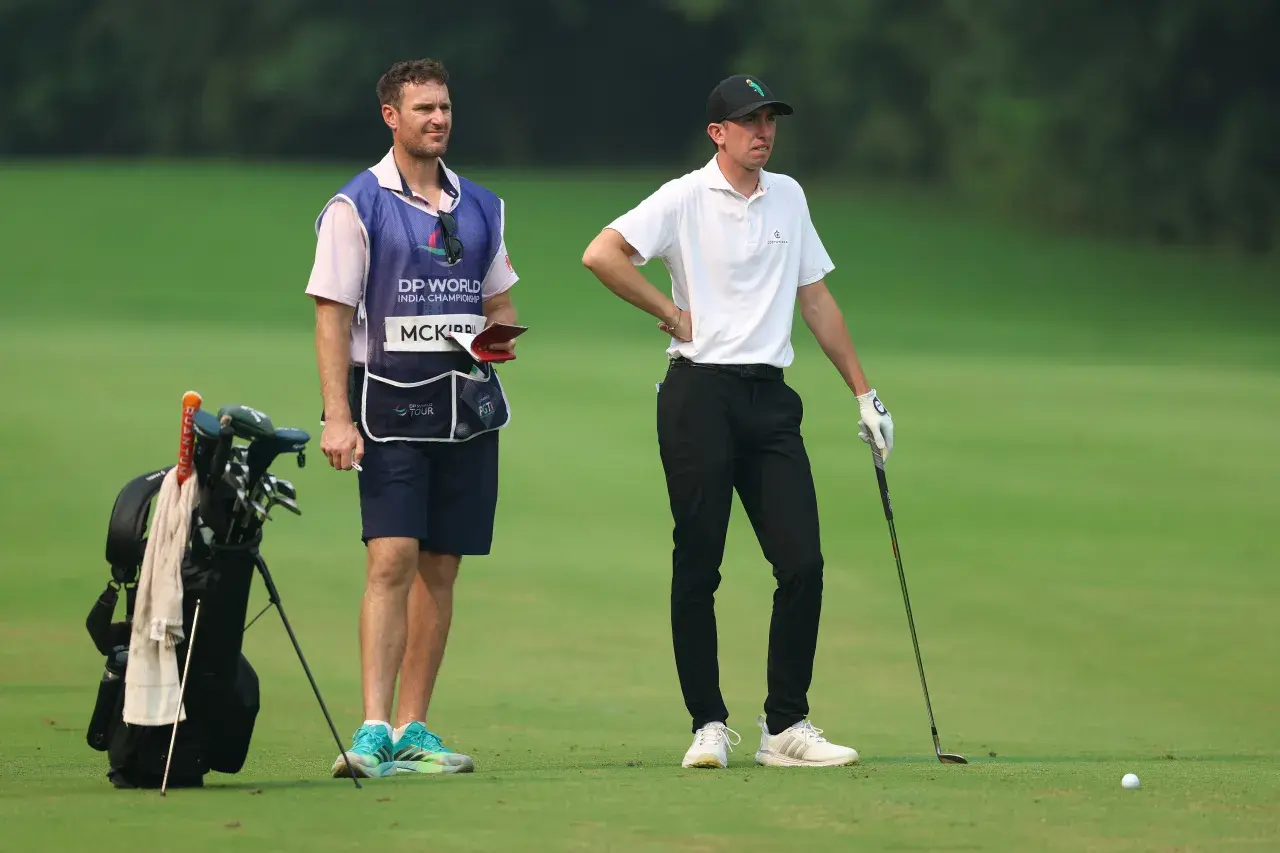 NEW DELHI, INDIA - OCTOBER 17 Tom McKibbin of Northern Ireland prepares to play his second shot with his caddie on the second hole on day three of the DP World India Championship at Delhi Golf Club on October 17, 2026.jpg